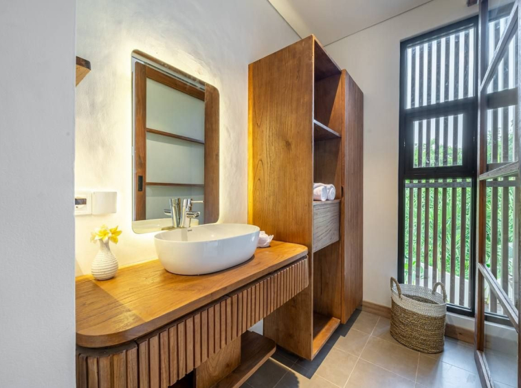 Bathroom with a timber vanity, vessel basin and louvred window