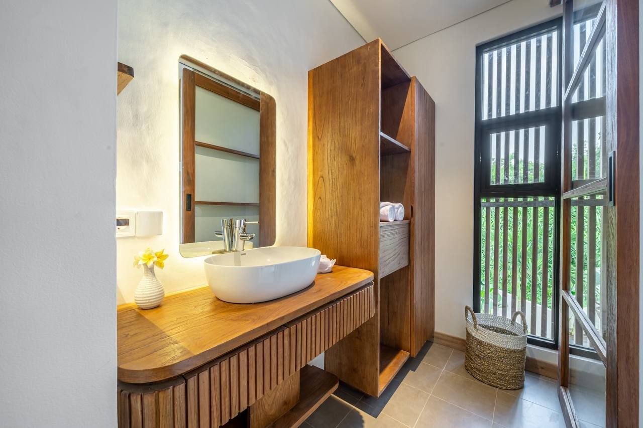 Bathroom with a timber vanity, vessel basin and louvred window
