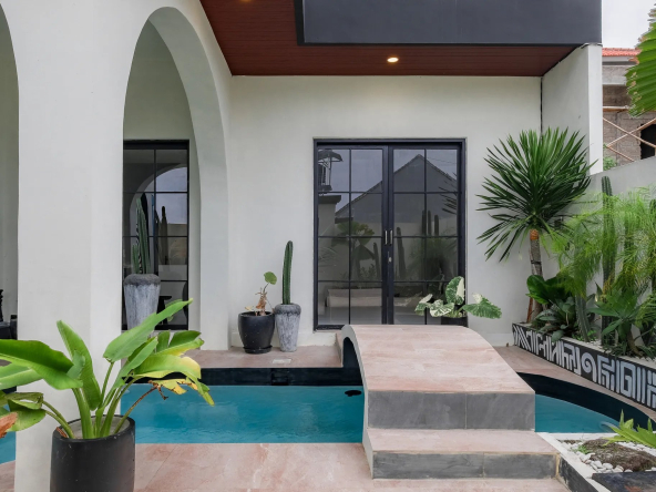 Villa facade with floor-to-ceiling glazing and the courtyard pool